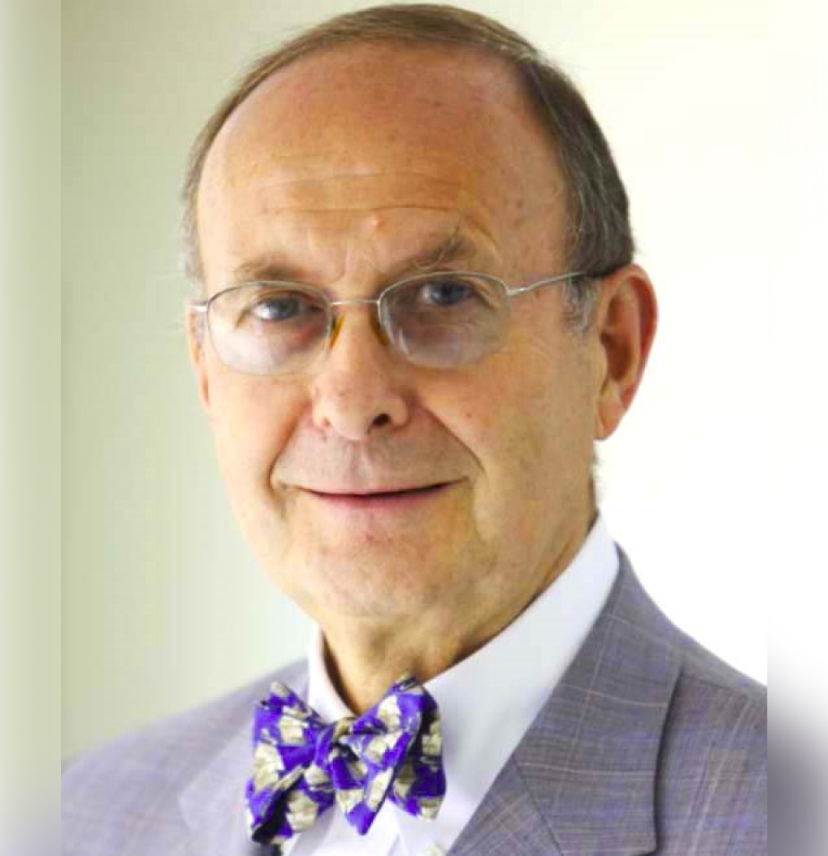 A man in a suit and tie wearing glasses.